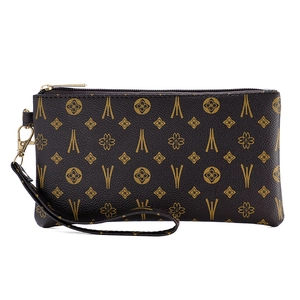 Vintage dark brown wristlet clutch with golden geometric patterns and zipper closure
