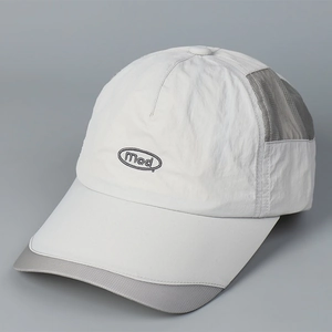 Detail view of quick-dry baseball cap featuring gray ripstop nylon and breathable mesh panels