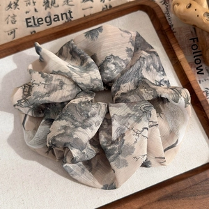 Detailed shot of ink wash landscape pattern on a sheer silk hair scrunchie in neo-Chinese style