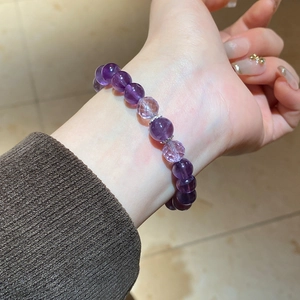 Detailed view of natural amethyst bead bracelet with faceted stones and silver spacers