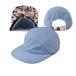 Light blue denim 5-panel camper hat with camouflage brim detail and adjustable back strap
