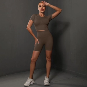 Close-up of high-waist seamless yoga shorts and short sleeve set in brown athletic fabric