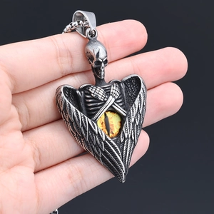 Close-up of gothic skull pendant with angel wings and evil eye in antique silver finish