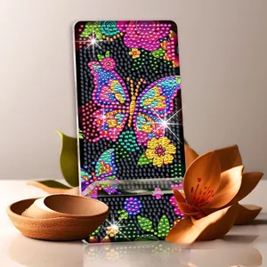 Detail of DIY diamond painting phone stand featuring a vibrant butterfly and floral pattern