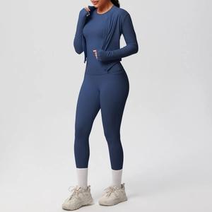 Detail of high-waist dark blue yoga leggings with functional side pockets and elastic fabric