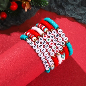 Detailed stack of Christmas clay bead bracelets with Merry Christmas letter beads and charms