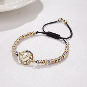 Detail of adjustable woven mama bracelet with gold beads and colorful zircon stones