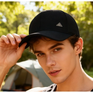 Detail of black winter baseball cap with ear flaps and premium metal logo badge