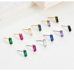 Detail view of baguette-cut colorful zircon stud earrings in various gold and silver finishes