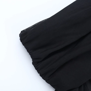 Close-up of premium black mesh fabric detail showing elastic micro-hole texture and weave