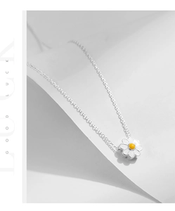 Detailed view of S925 sterling silver daisy pendant with white enamel on a delicate O-chain