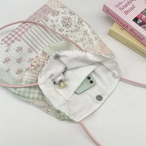 Detail view of floral canvas tote bag interior with zipper pocket and magnetic closure
