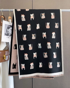 Close-up of a soft knitted cat pattern scarf with fringe and double-sided jacquard design