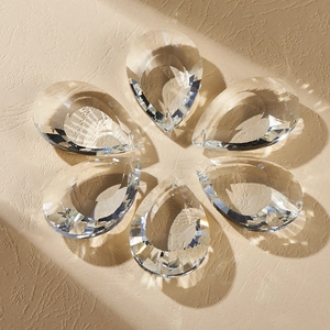 Teardrop crystal pendants arranged in a floral pattern for suncatchers and home decor