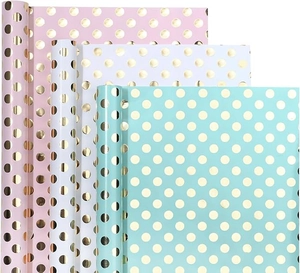 Detail of colorful polka dot gift wrapping paper rolls in pink, white, and mint green