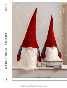 Detail of red and grey felt Christmas gnomes with warm light background scenery