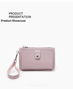 Detail of lavender litchi leather coin purse with wrist strap and zipper closure