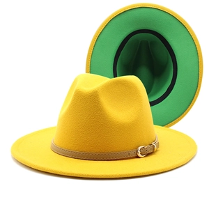 Detail of yellow wool fedora featuring khaki leather belt and vibrant green lining