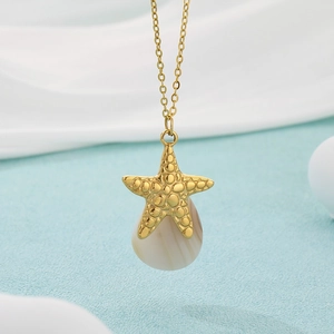 Detail of 18K gold plated starfish pendant with beige shell teardrop on a fine gold chain