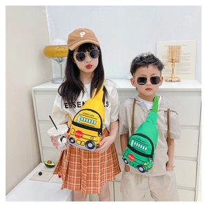 Detail of school bus shaped crossbody bag with zipper and cartoon graphic on kids