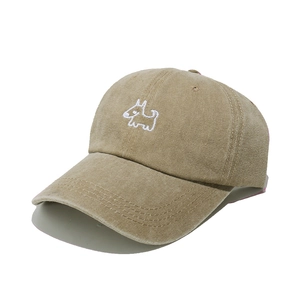 Close-up of cute white puppy embroidery on khaki washed cotton baseball cap brim