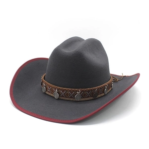 Dark grey felt cowboy hat featuring red trim, ethnic braided band, and vintage metal coins