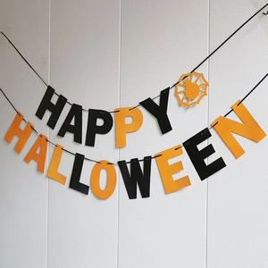 Detail of Happy Halloween paper banner with orange spider web and black letter flags