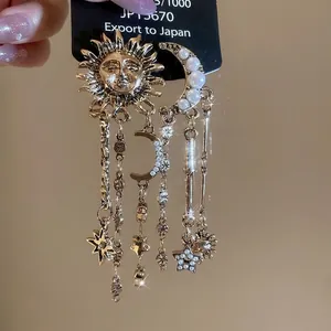 Asymmetric vintage celestial earrings with gold sun, moon, stars and pearl tassels