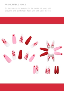 Detailed view of long ballerina press-on nails with heart patterns and rhinestone accents