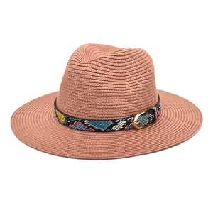 Detail of wide brim straw fedora with colorful geometric ribbon and gold buckle
