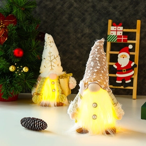 Glow Christmas gnomes with LED lights, snowflake hats, and pine cones on festive wooden table