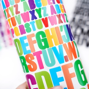 Macro shot of colorful alphabet stickers featuring A-Z letters for scrapbook decoration