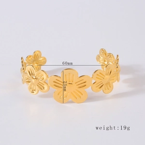 Detail of gold floral cuff bracelet showing 60mm diameter and 25mm flower height