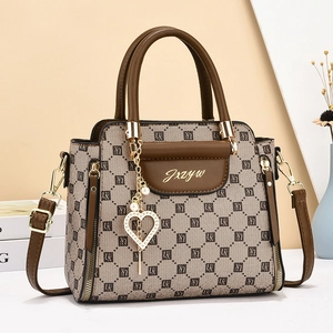 Brown leather and beige monogram handbag with heart pendant and pearl chain detail
