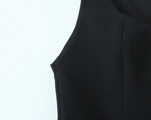 Detail of armhole stitching and smooth black elastic fabric on sleeveless vest top