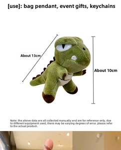 Close-up of green plush dinosaur keychain with dimensions and metal lobster clasp detail