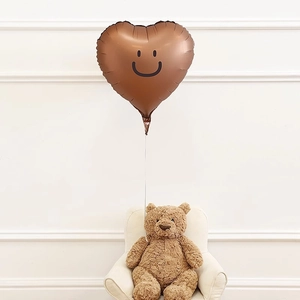 Close-up of a 18-inch brown heart-shaped smile balloon for party decorations