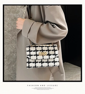 Detail of tweed crossbody bag with metallic chain strap and gold-tone turn-lock closure