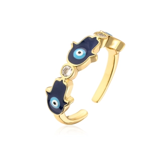 Macro view of 18K gold plated Hamsa Hand and Evil Eye ring with blue enamel and zircon