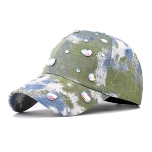 Detailed view of colorful tie-dye baseball cap featuring hand-set shimmering rhinestones