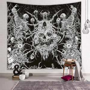 Black and white skull wall tapestry hanging on a white brick wall in a cozy room decor