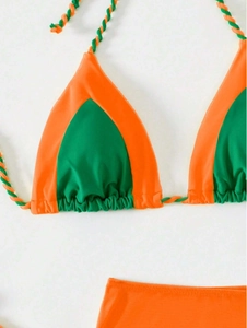 Detail of bikini top with orange and green color block and twisted cord straps