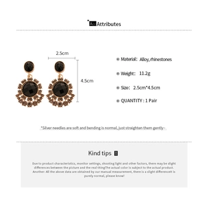 Detail view of vintage sunflower drop earrings with black stones and sizing specifications