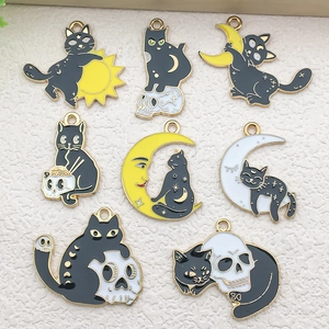 Detailed collection of black enamel cat pendants featuring moon, sun and skull motifs