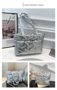 Detail view of quilted silver tote bag featuring high-shine finish and FASHION logo label