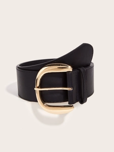 Detailed close-up of a wide black leather belt with a large vintage gold D-buckle