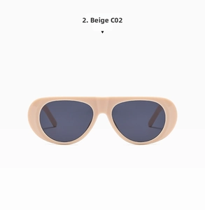 Detail view of beige matte aviator sunglasses frames with dark tinted lenses