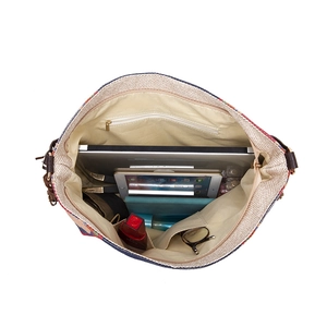 Detailed interior of woven bohemian tote bag featuring multiple pockets and compartments