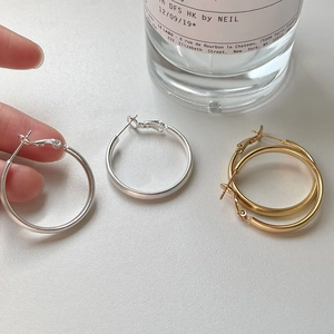 Minimalist brushed metal hoop earrings in silver and gold finishes for a modern look