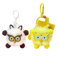 Close-up of white and yellow plush cat ball keychains with plastic glasses and clips